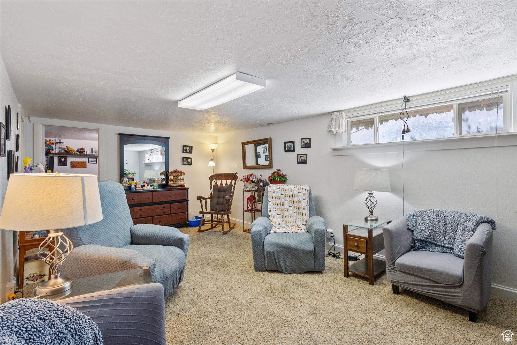 Living room featuring a textured ceiling and carpet flooring