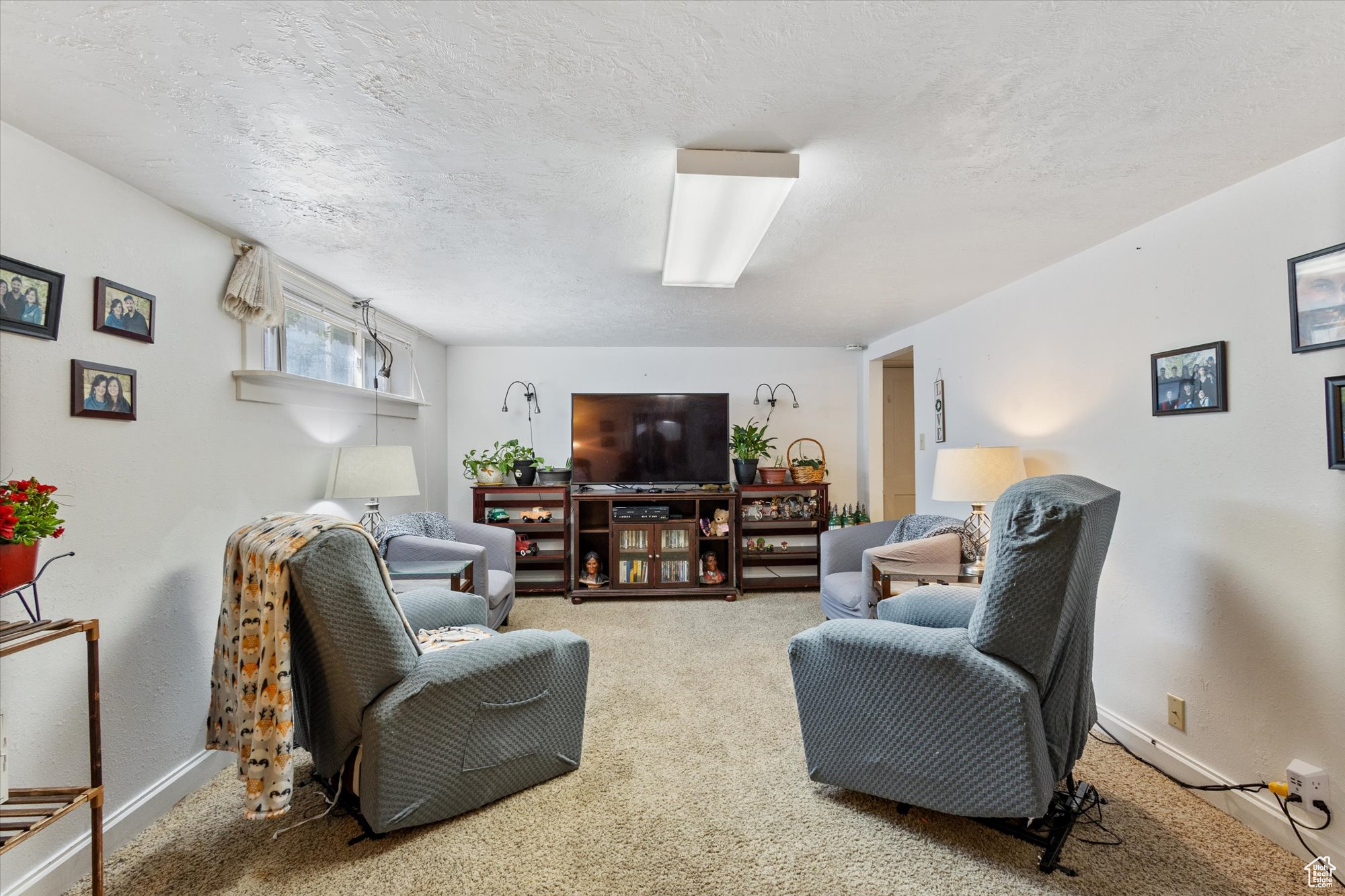 Living room featuring a textured ceiling and carpet