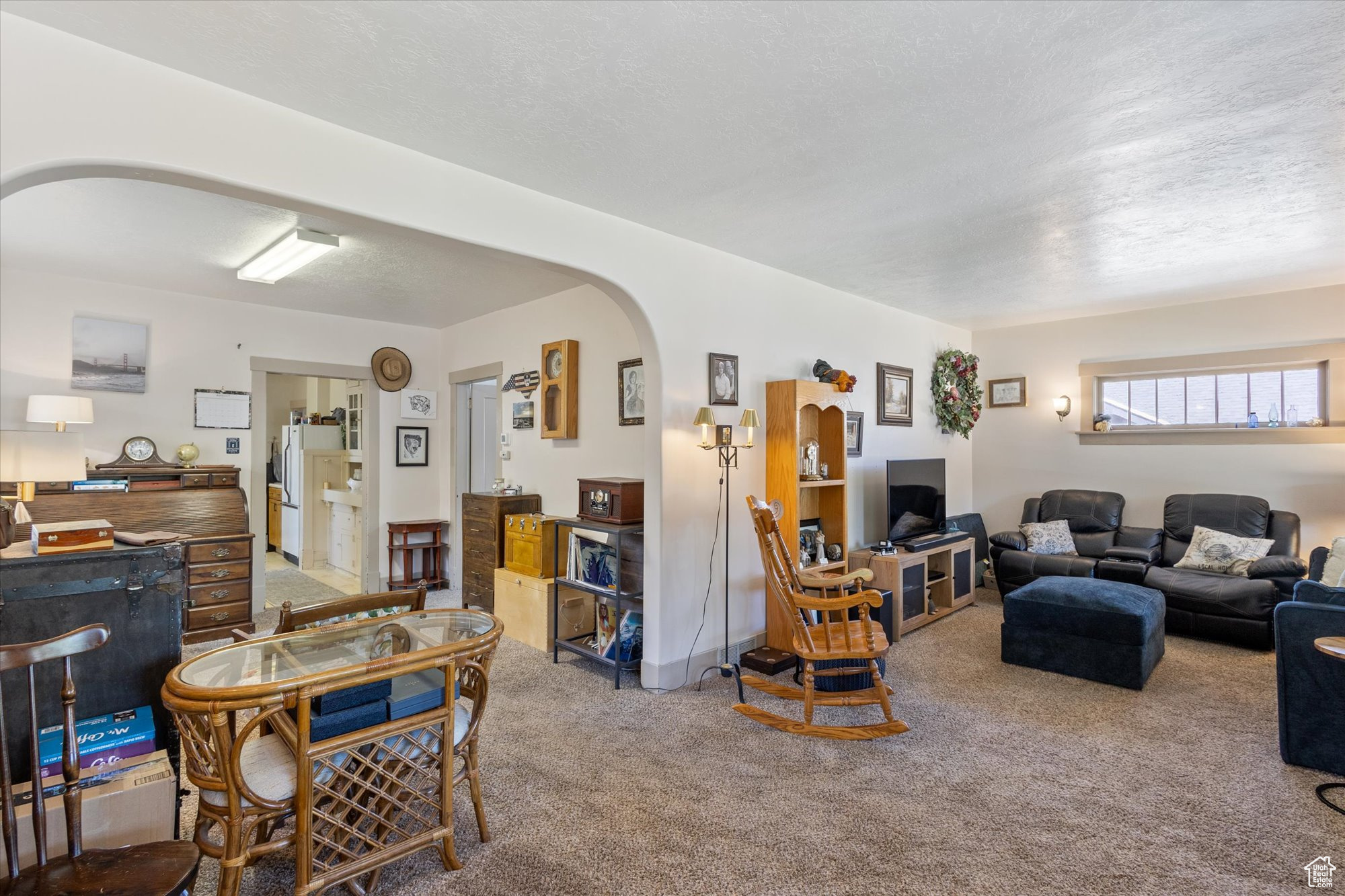 Living room featuring a textured ceiling and carpet