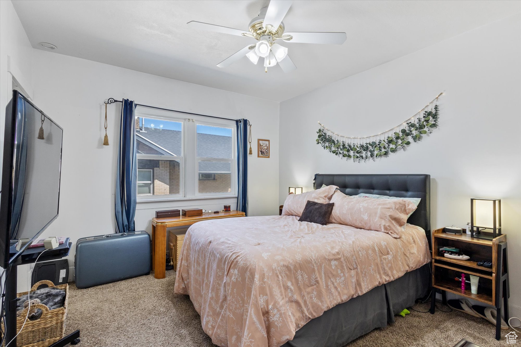 Carpeted bedroom with ceiling fan