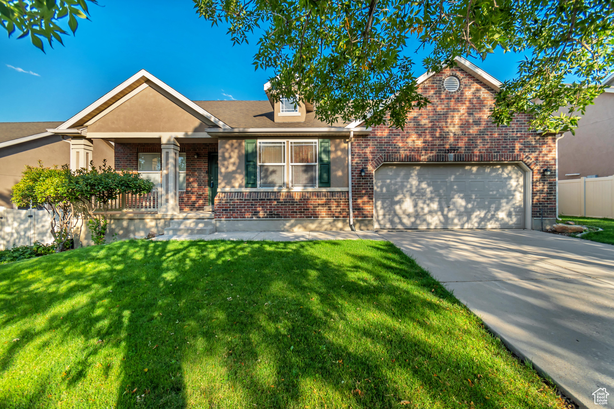 View of front of home featuring a garage and a front lawn