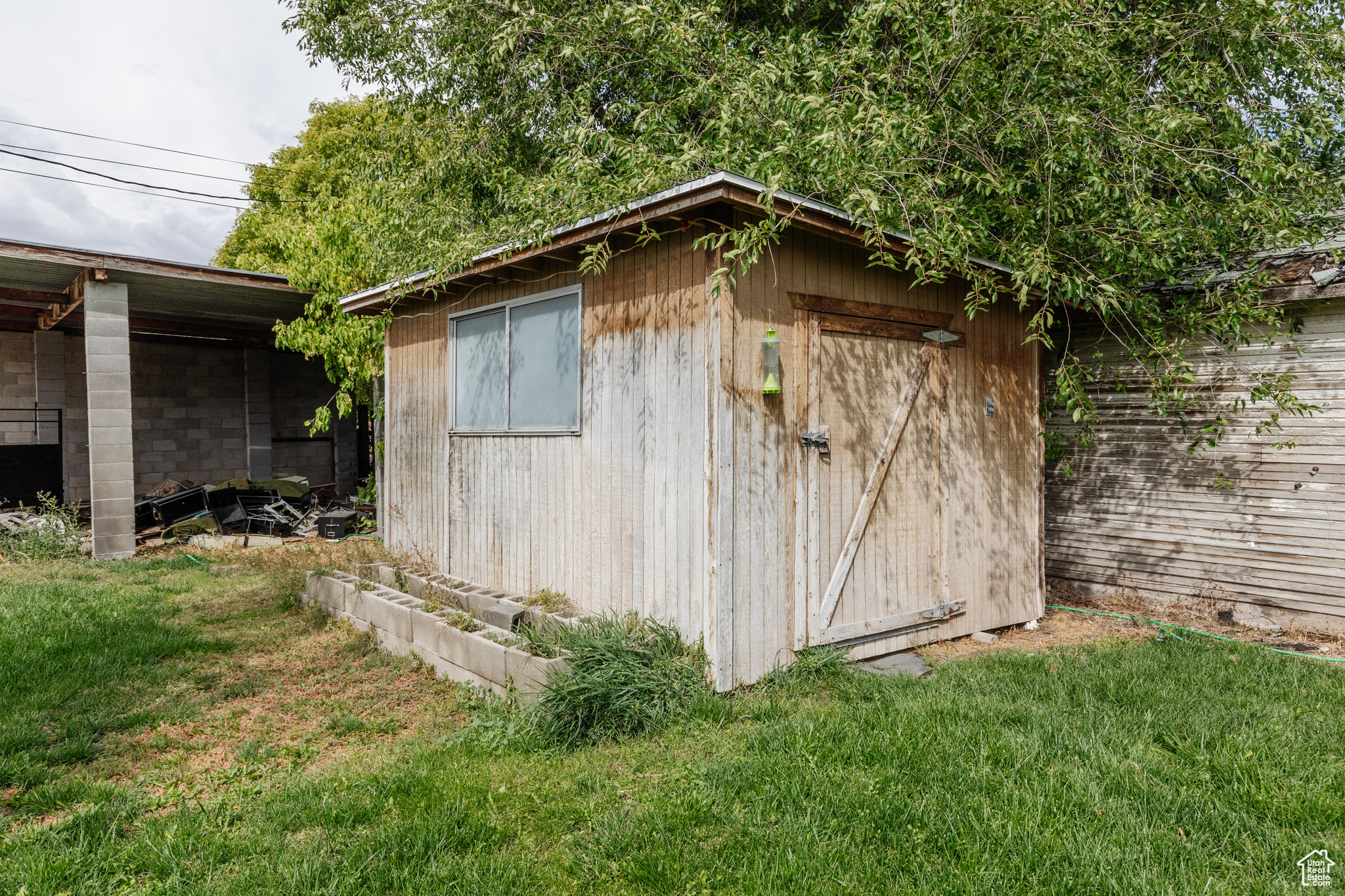 View of outbuilding with a yard