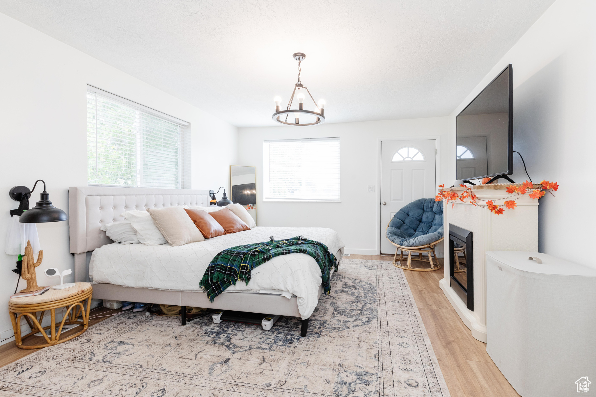 Bedroom with a notable chandelier and light wood-type flooring