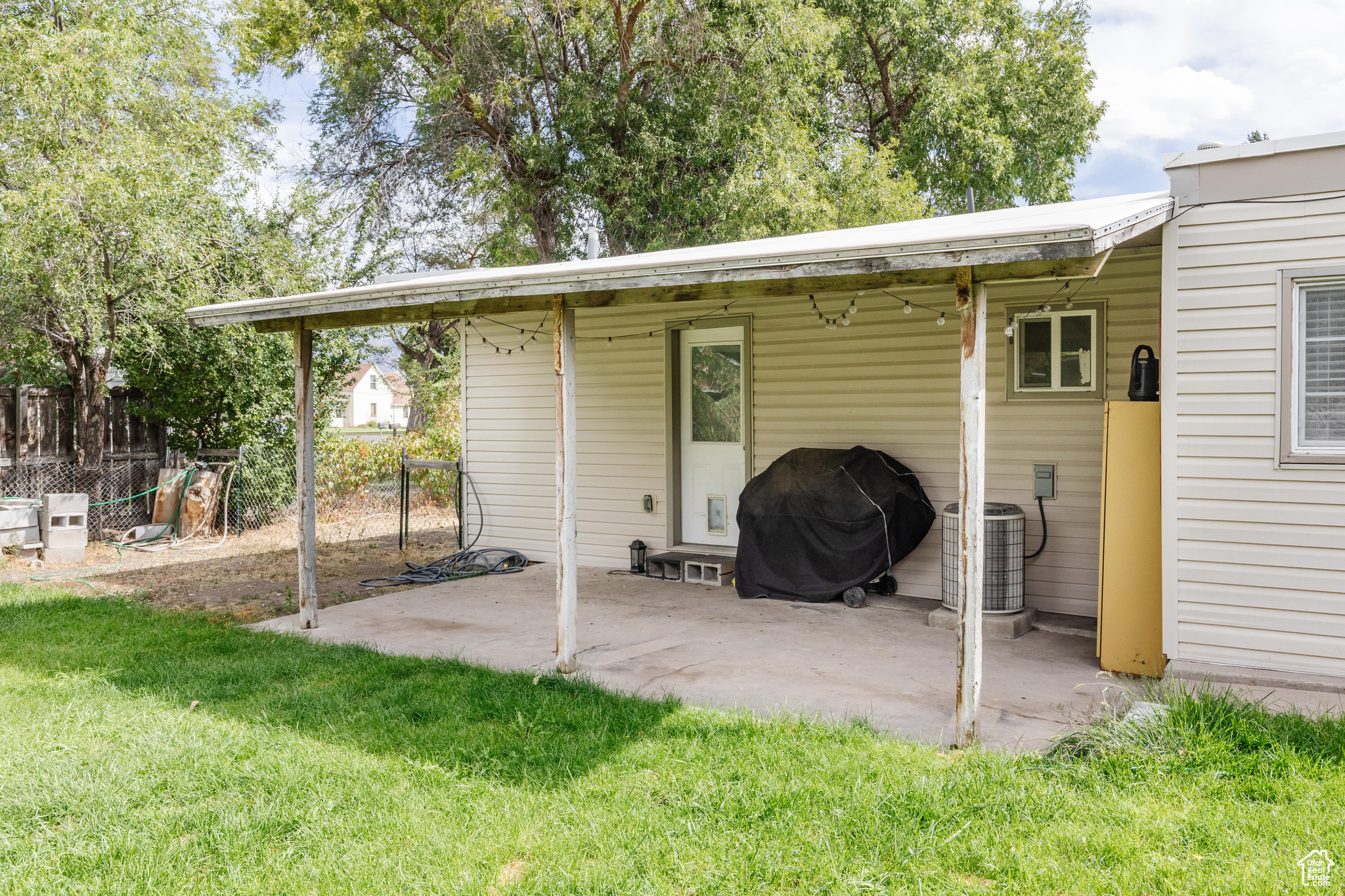 View of patio featuring area for grilling and central AC