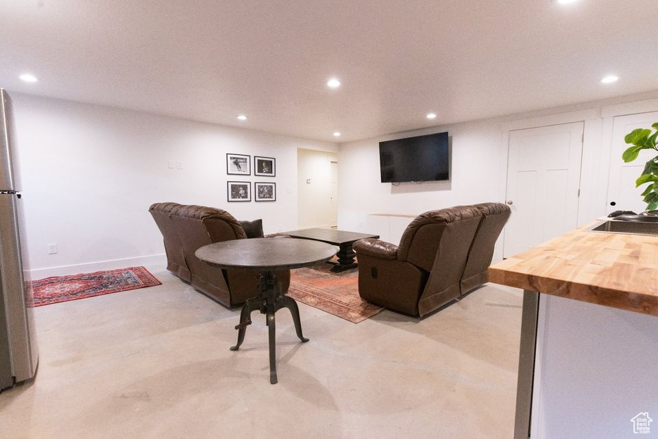 Carpeted living room featuring sink