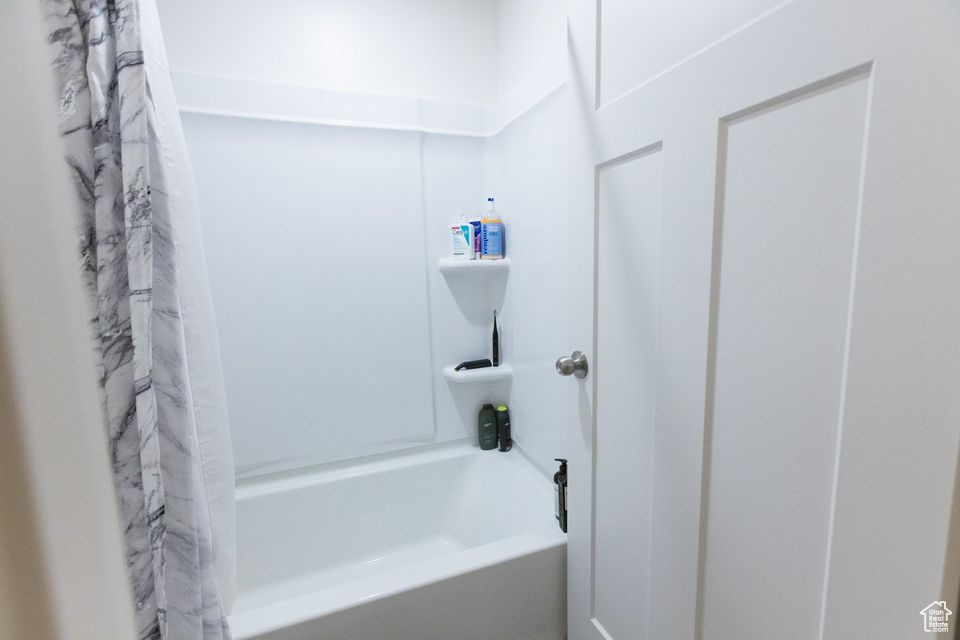 Bathroom featuring shower / bath combo with shower curtain