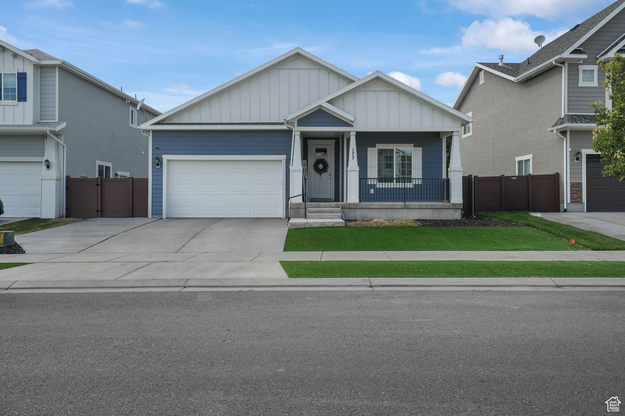 View of front of property with a garage and a porch