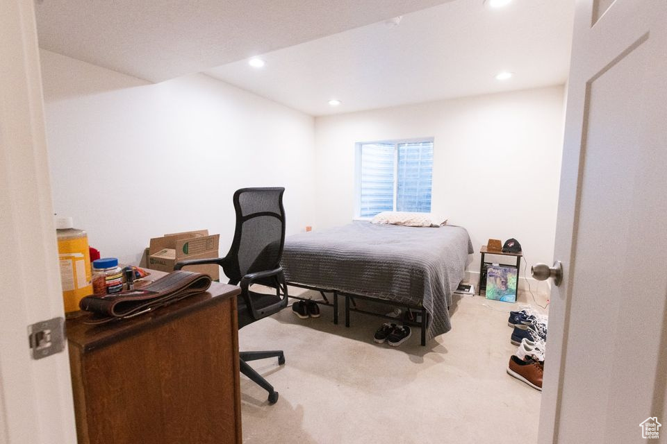 Bedroom featuring light colored carpet