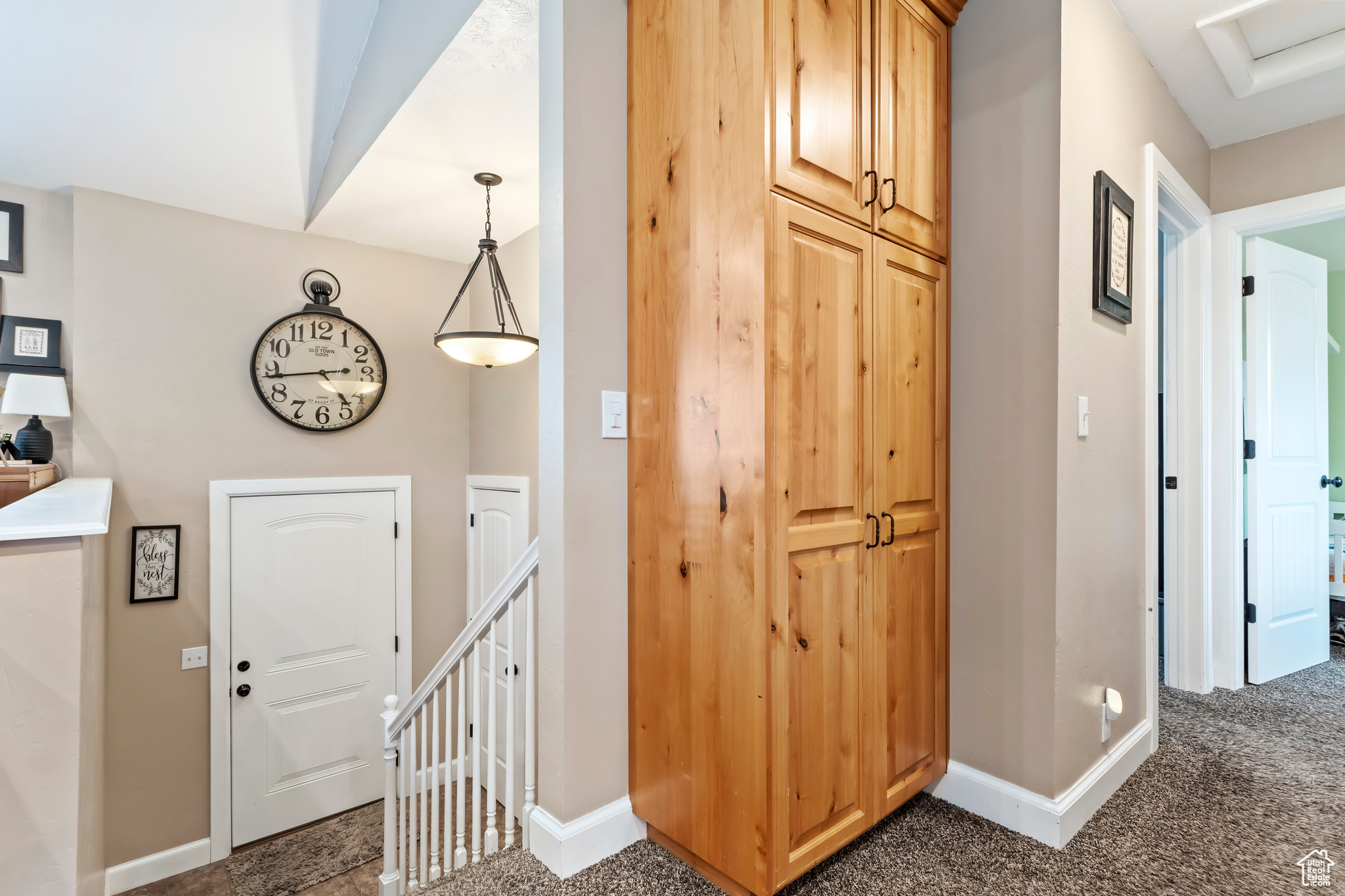 Hall featuring dark colored carpet