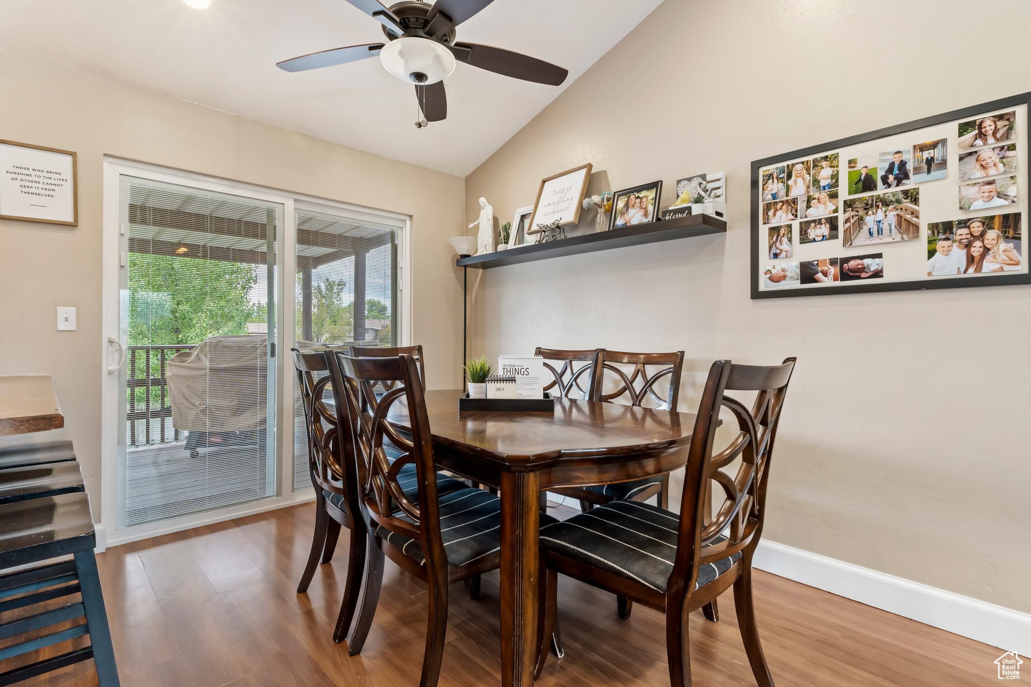 Dining room with vaulted ceiling, hardwood / wood-style floors, and ceiling fan