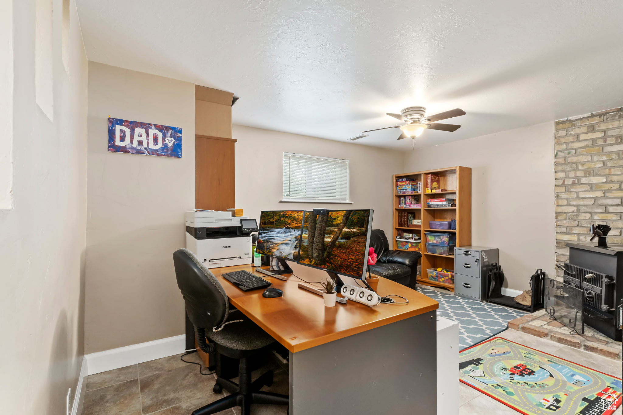 Home office with ceiling fan and a textured ceiling