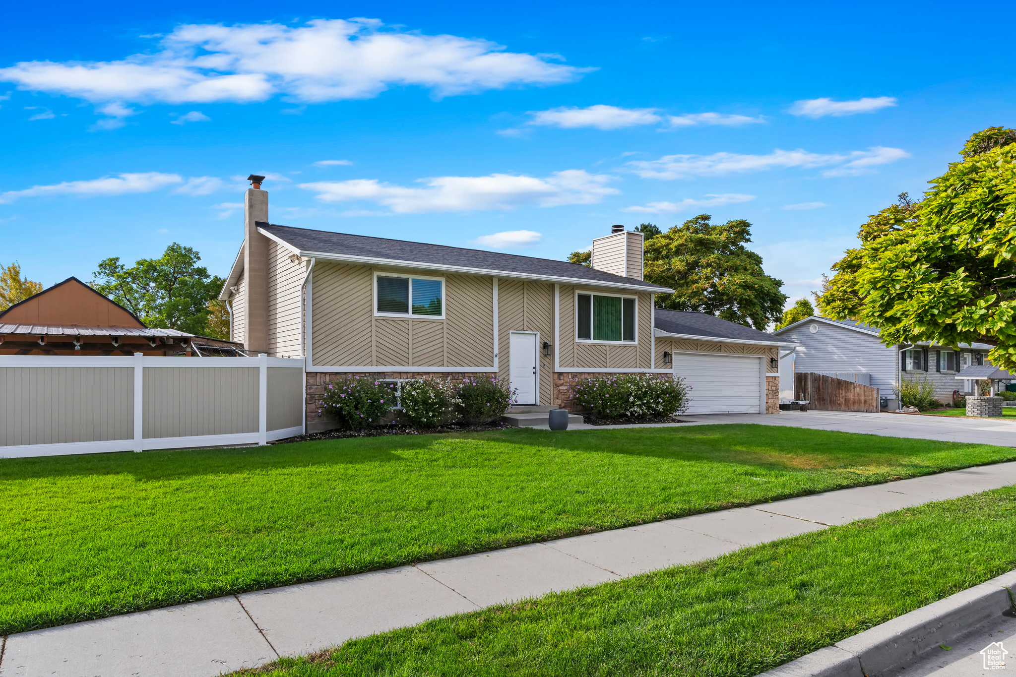 Raised ranch with a garage and a front yard