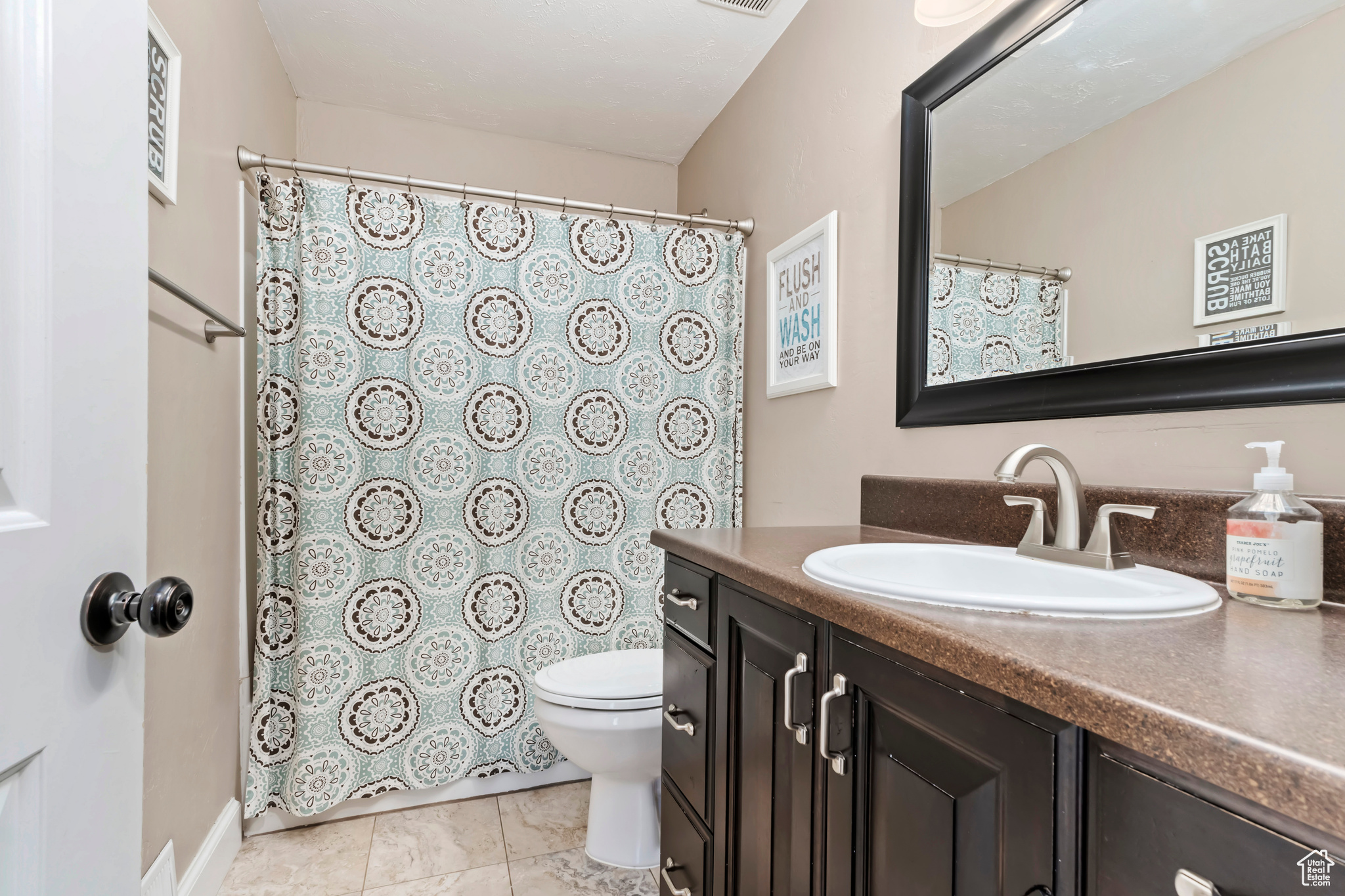 Bathroom with walk in shower, vanity, and toilet