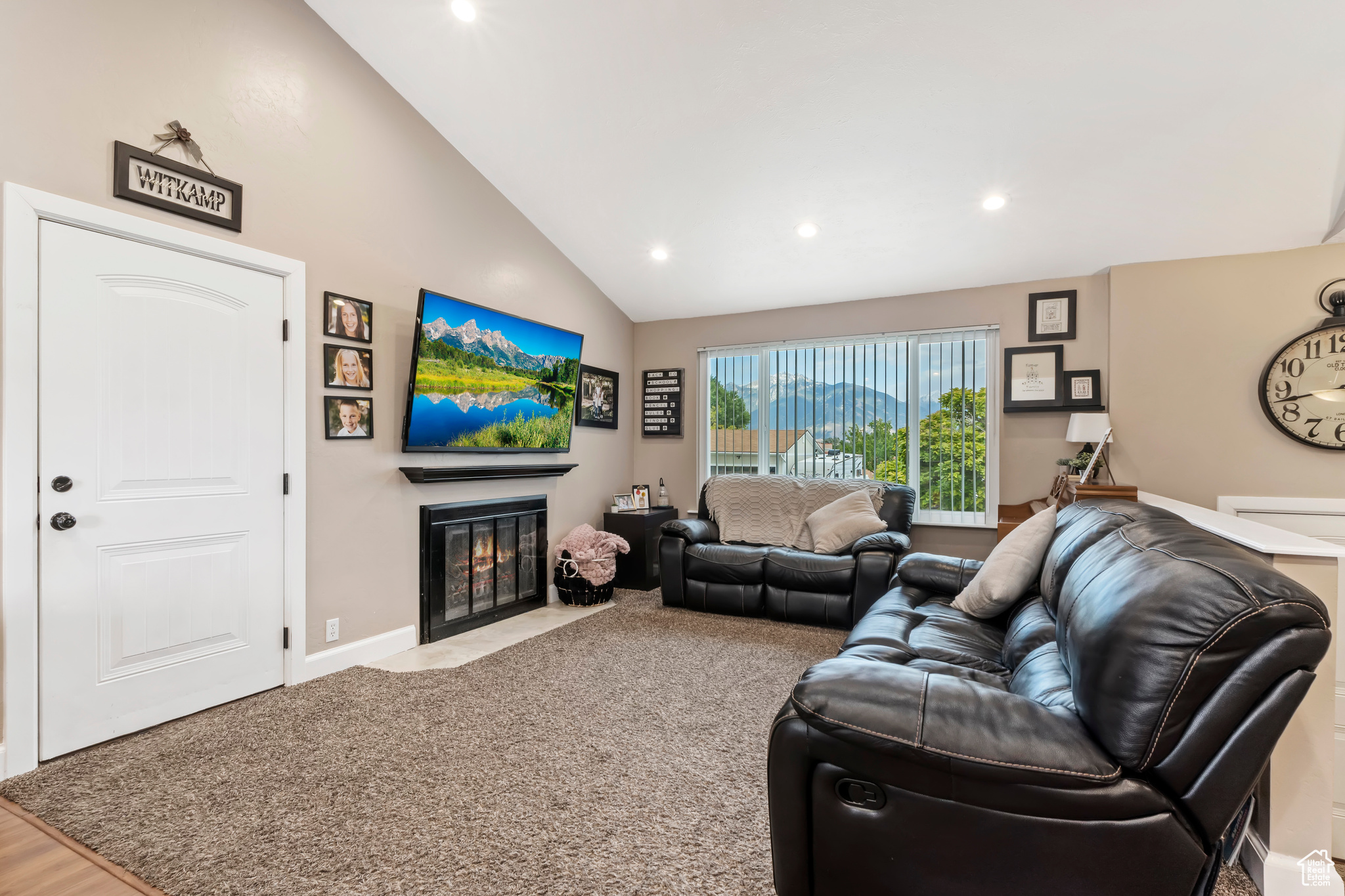 Carpeted living room with lofted ceiling