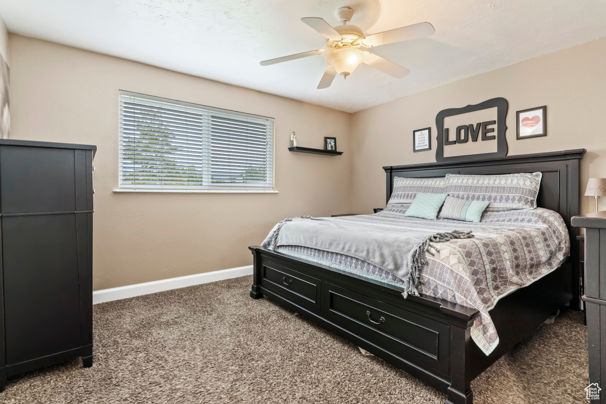 Carpeted bedroom with ceiling fan