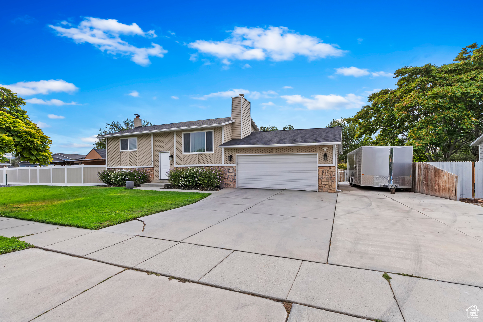 View of front of property featuring a front yard and a garage