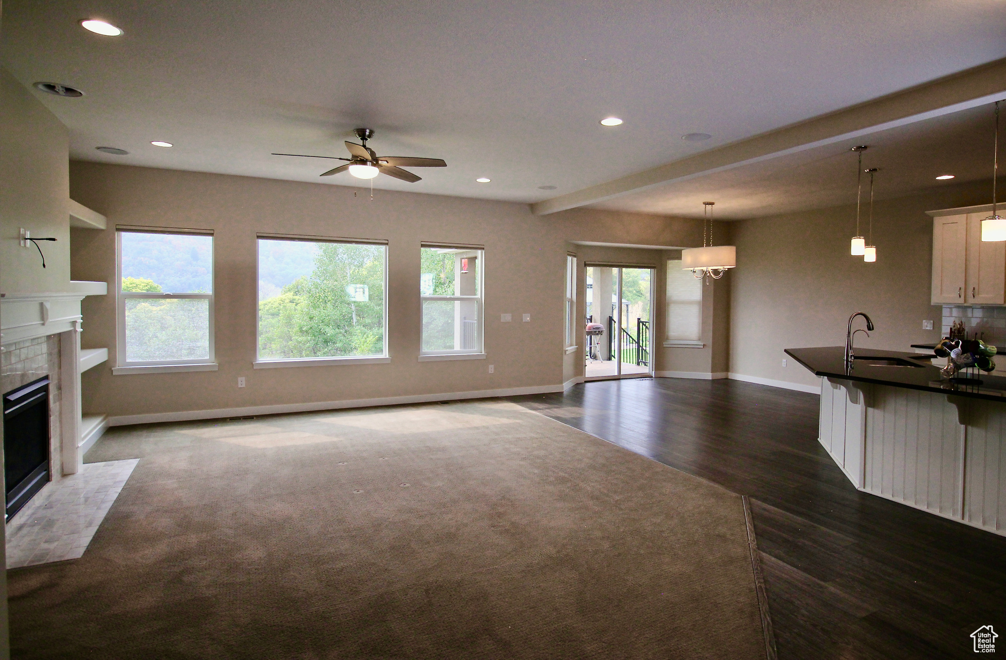 The great room is an open palette inviting you to gather with family and friends. The great room features a ceiling fan, dark hardwood / wood-style floors, and opens to the large kitchen.