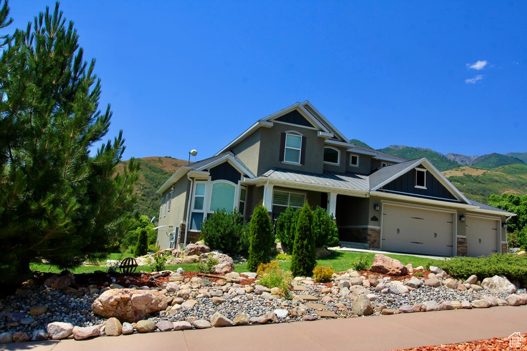 Craftsman inspired home with a mountain view and a garage