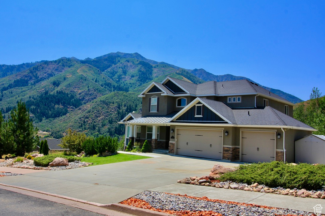 View of front of property with a mountain view and a garage