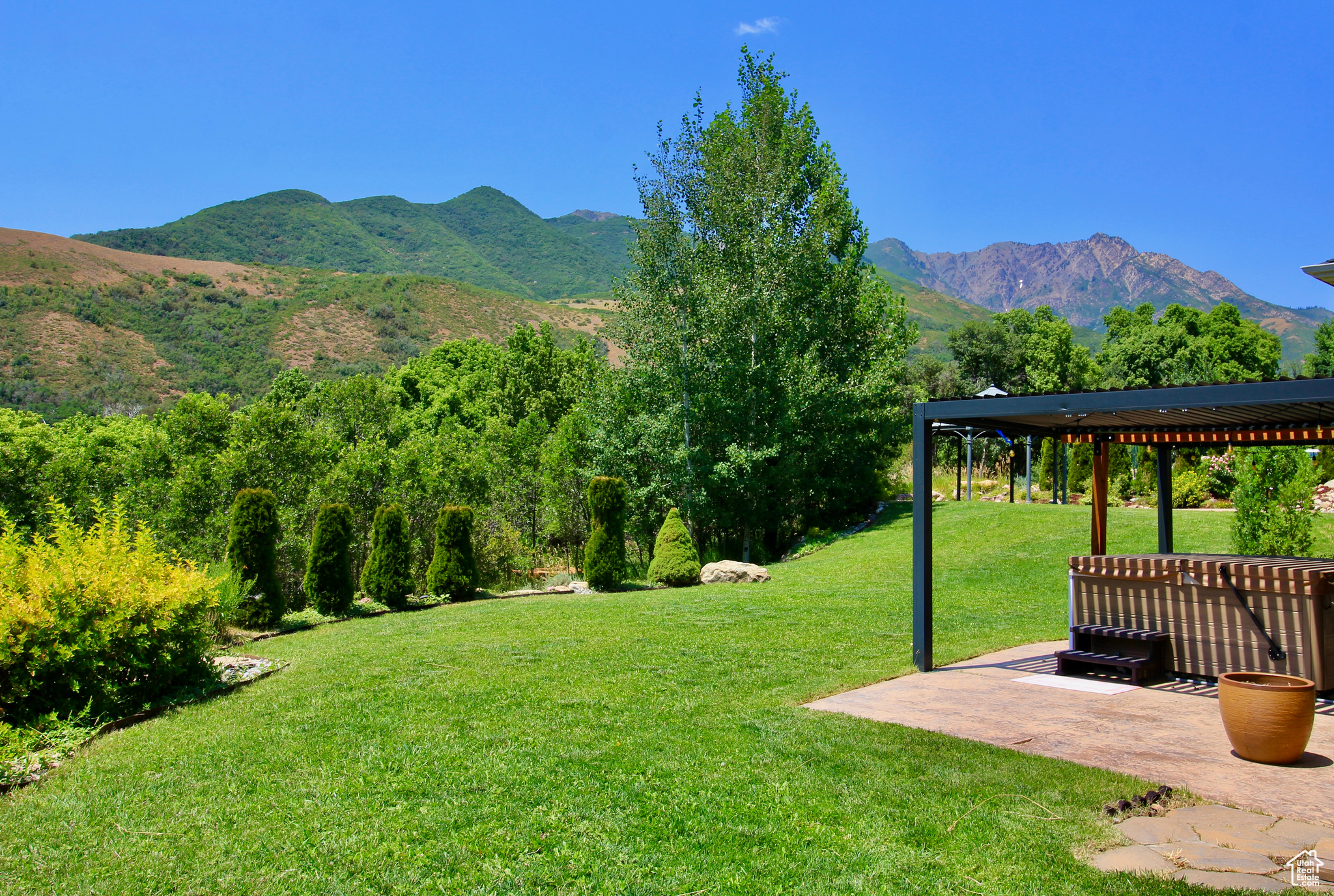 View of yard featuring a mountain view, a pergola, and a patio area