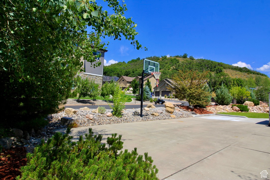 The side cemented area has space for play; a game of hoops or perhaps your recreational vehicle would be equally at home here.