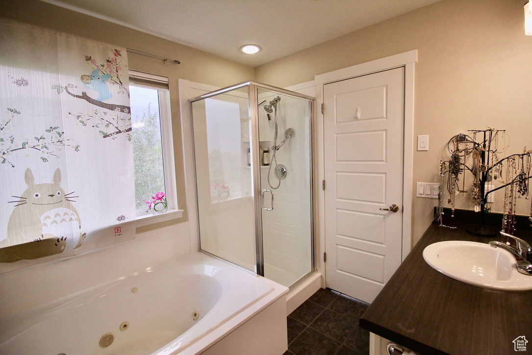 second-floor main bedroom bath that includes a vanity, toilet, shower, tub, and walk-in closet.