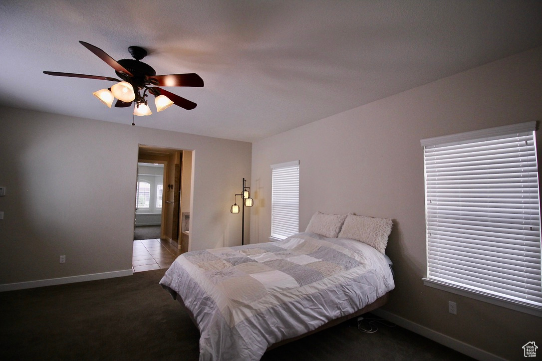 Bedroom with ceiling fan and carpet