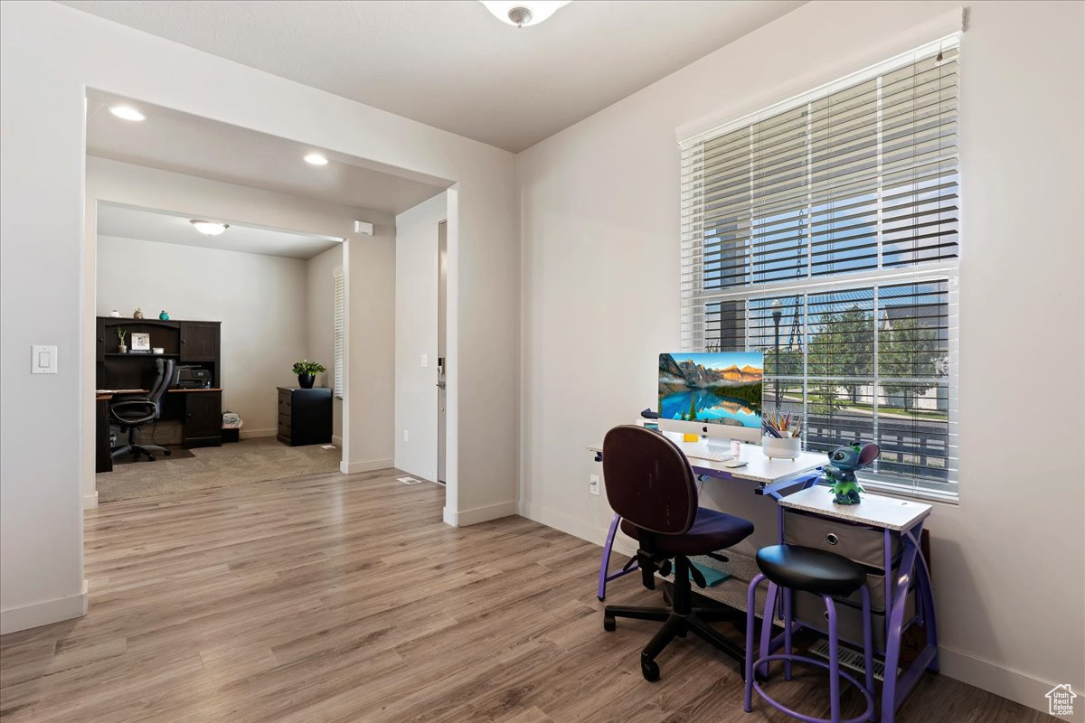 Inside entry way with office on one side and living room/formal dining area on the other side.