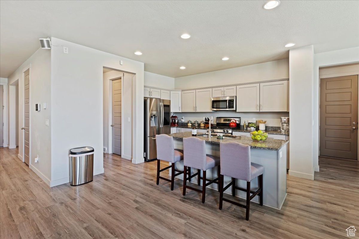 Kitchen with granite countertops and hallways to pantry