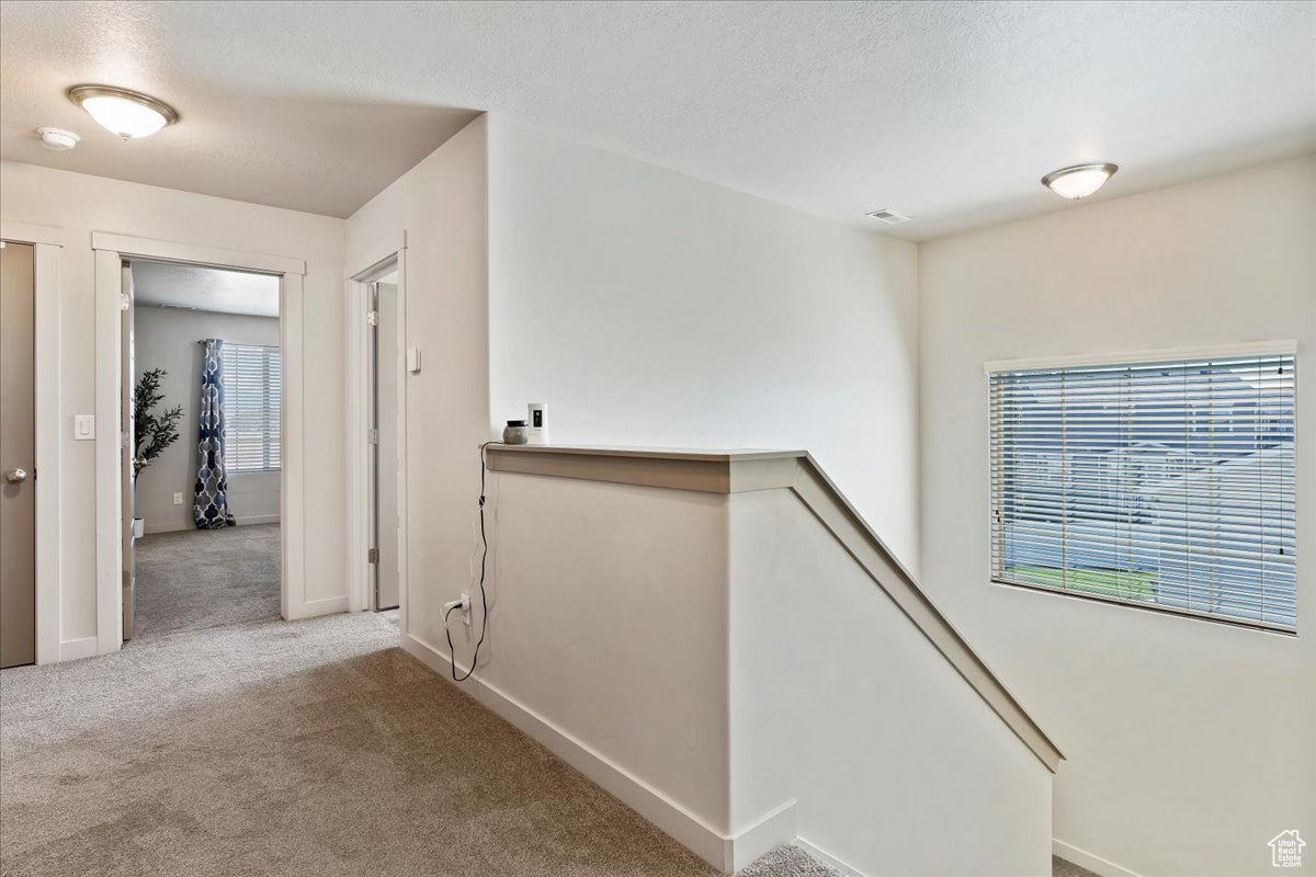 Hallway upstairs to 4 bedrooms, laundry room, and full bathroom