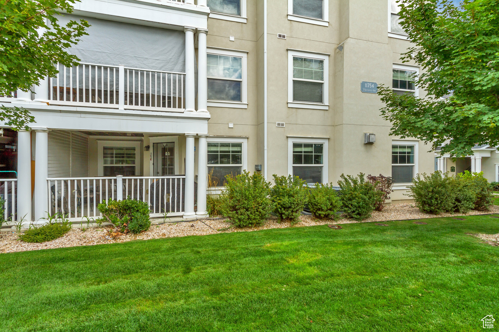 View of green space with the unit's covered patio