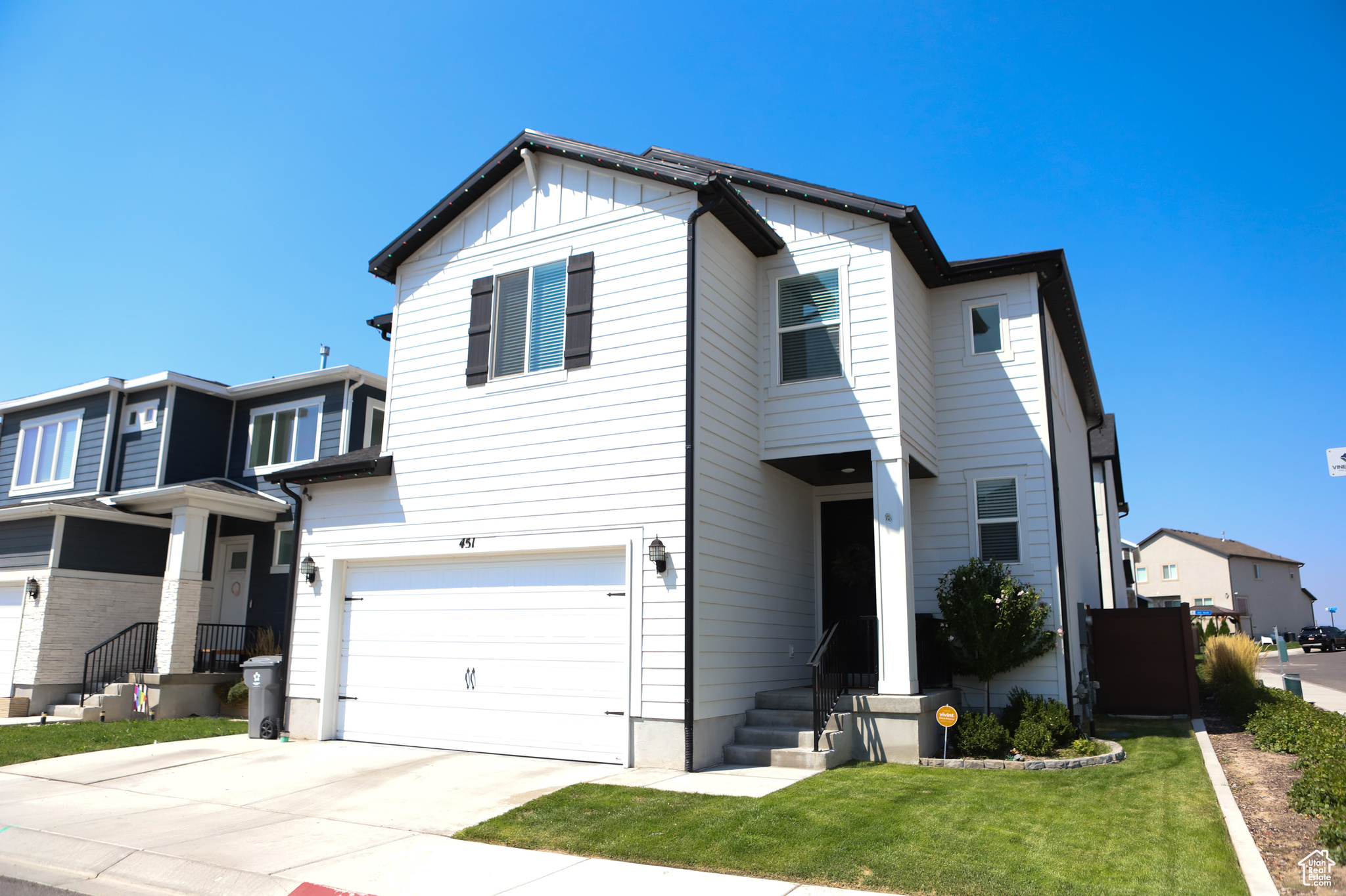 View of front property with a front lawn and a garage