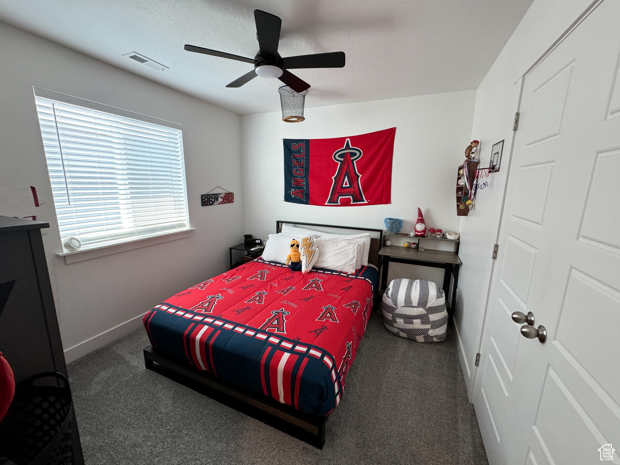 Carpeted bedroom with ceiling fan