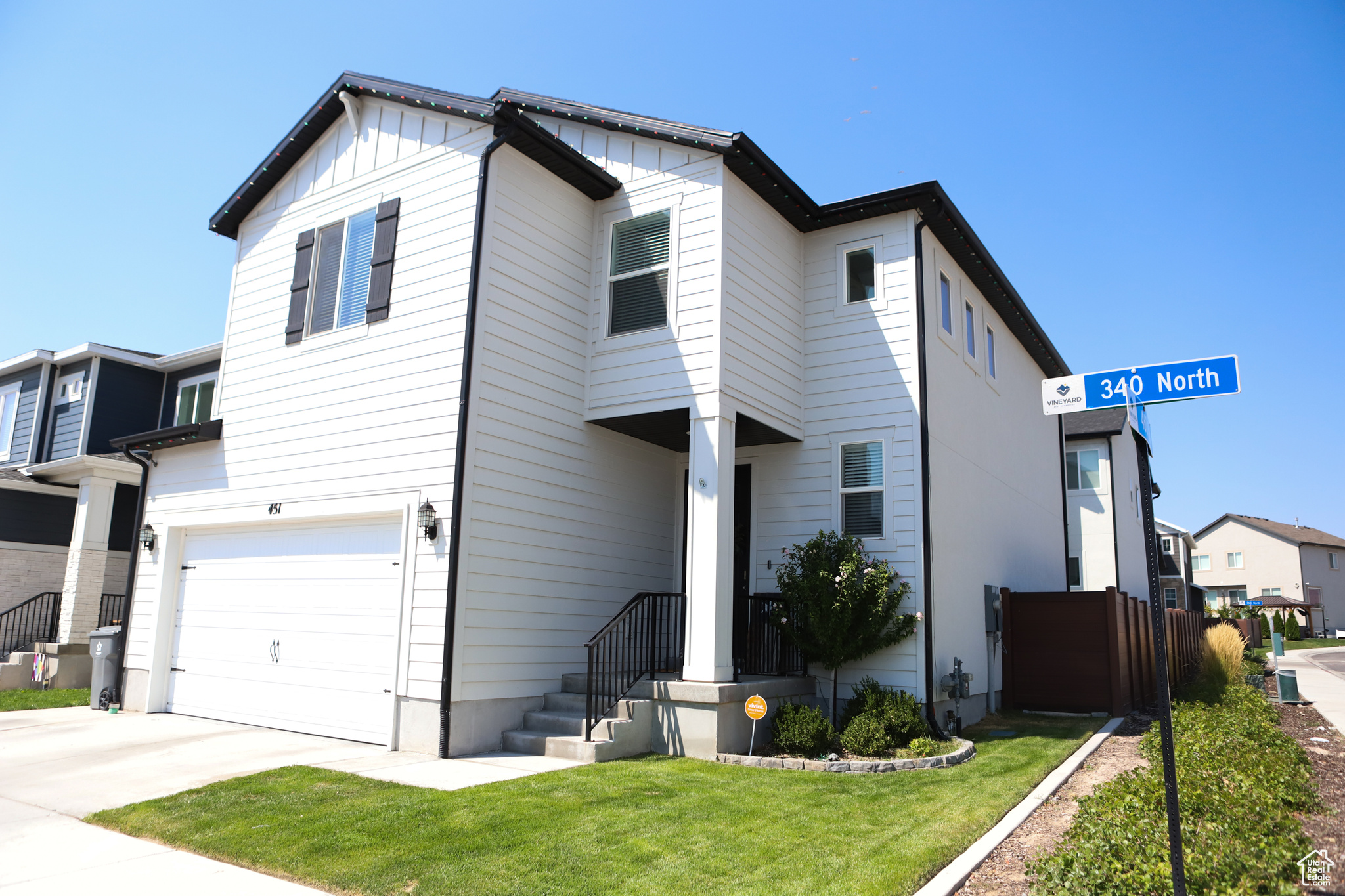 View of front of property featuring a garage and a front yard