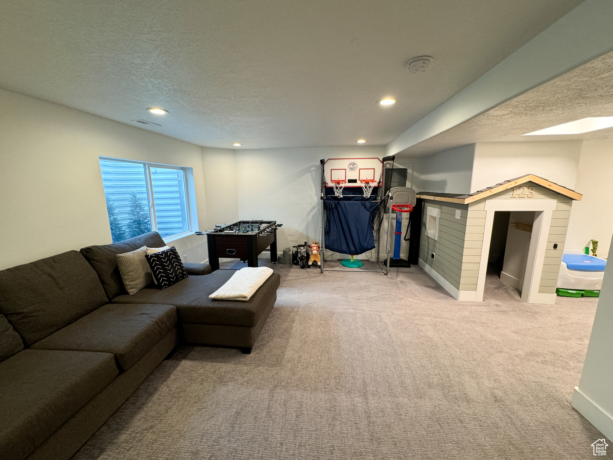 Living room featuring light carpet and a textured ceiling