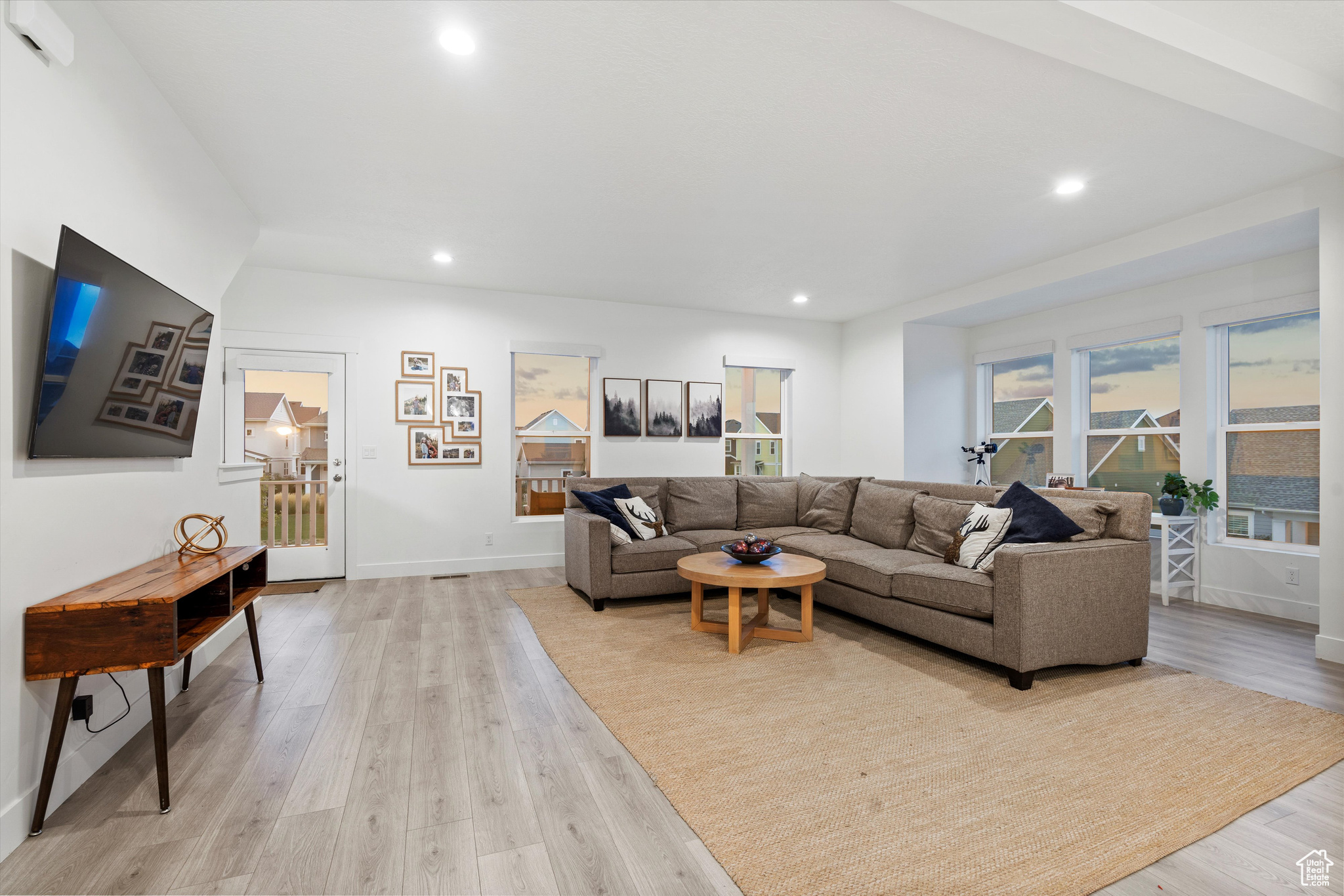 Looking from kitchen to living room area, facing toward the balcony door.