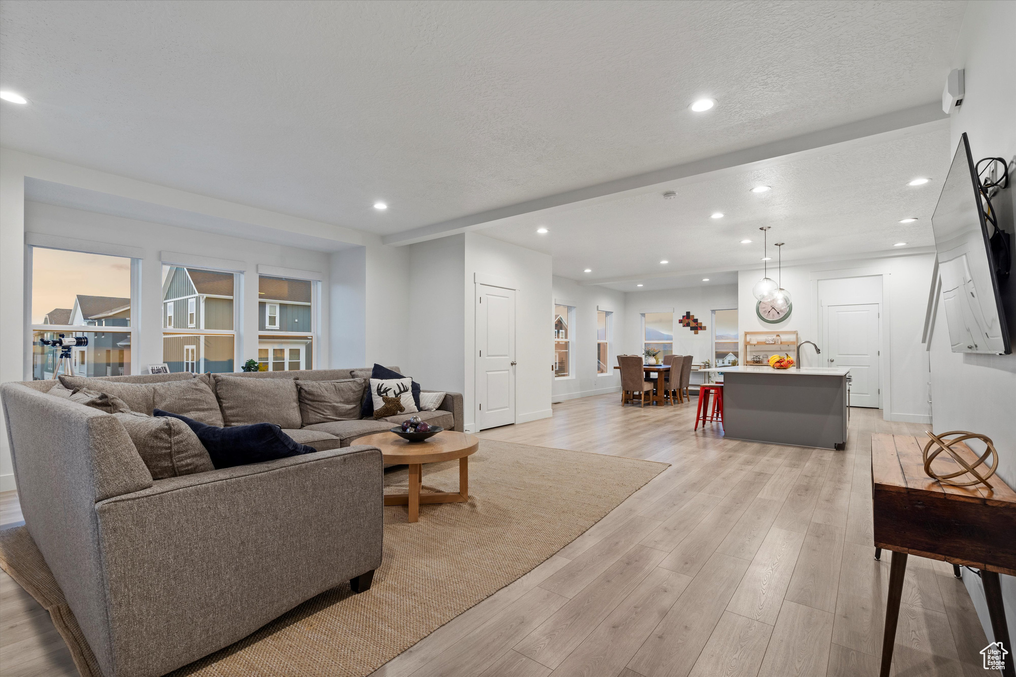 Great room, standing at the balcony entrance looking toward the kitchen and dining.