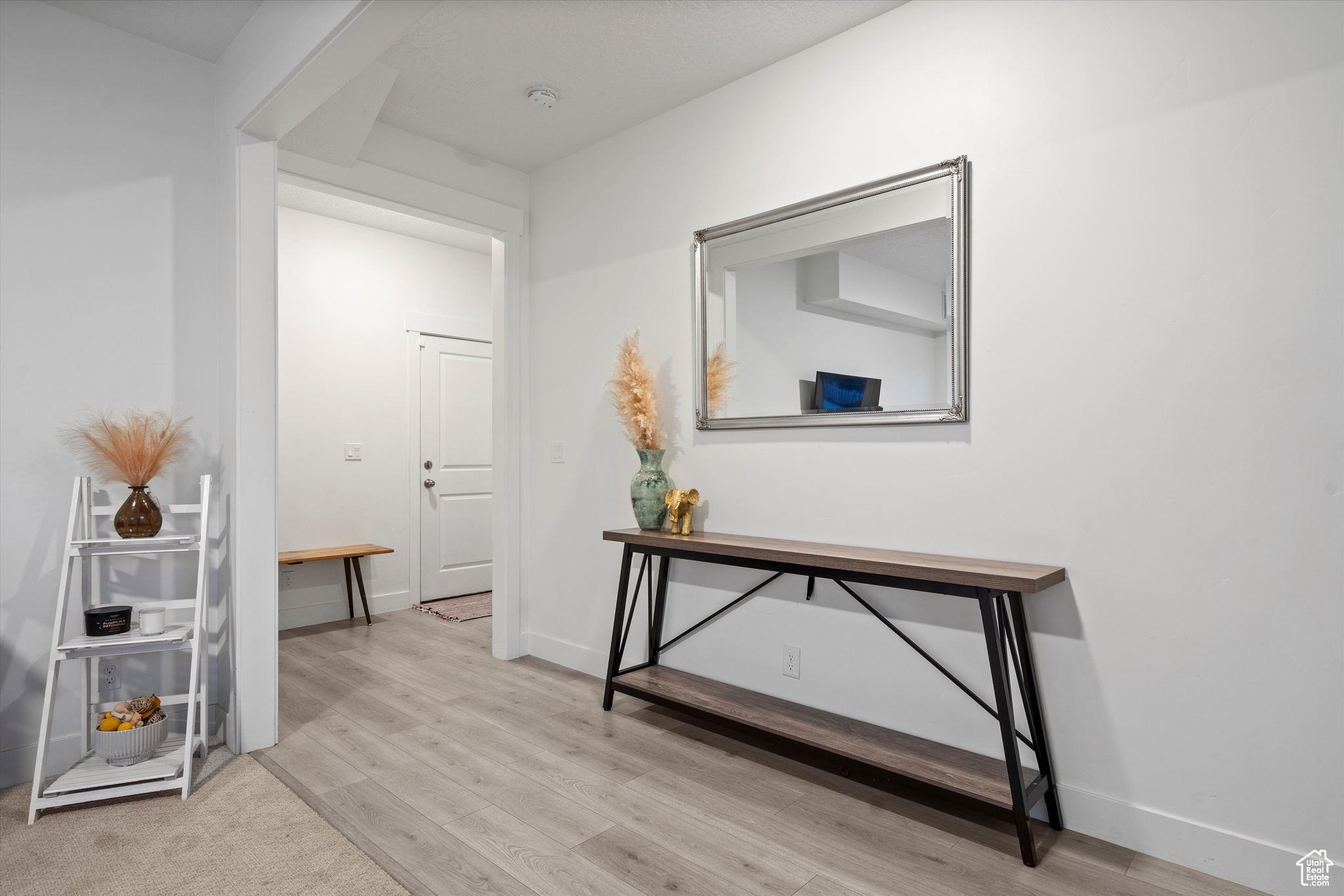 Corridor leading to a coat closet, garage door and turn to staircase.