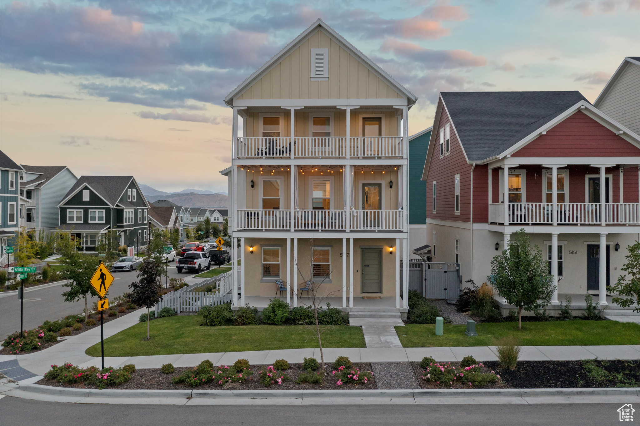 View of front of home featuring a balcony, a yard, and covered porch