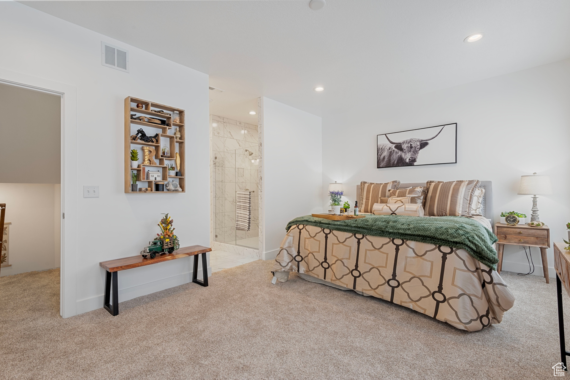 Carpeted bedroom with connected bathroom