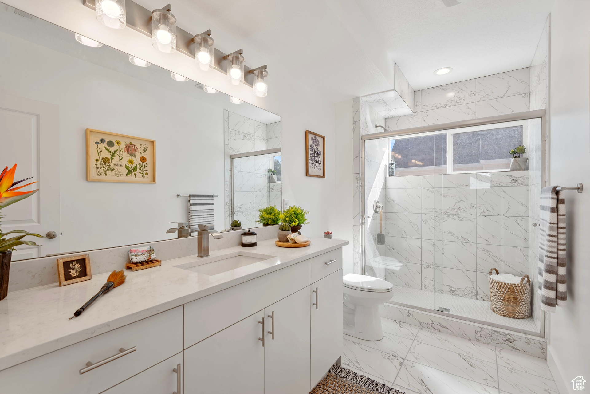 Bathroom featuring vanity, toilet, and an enclosed shower