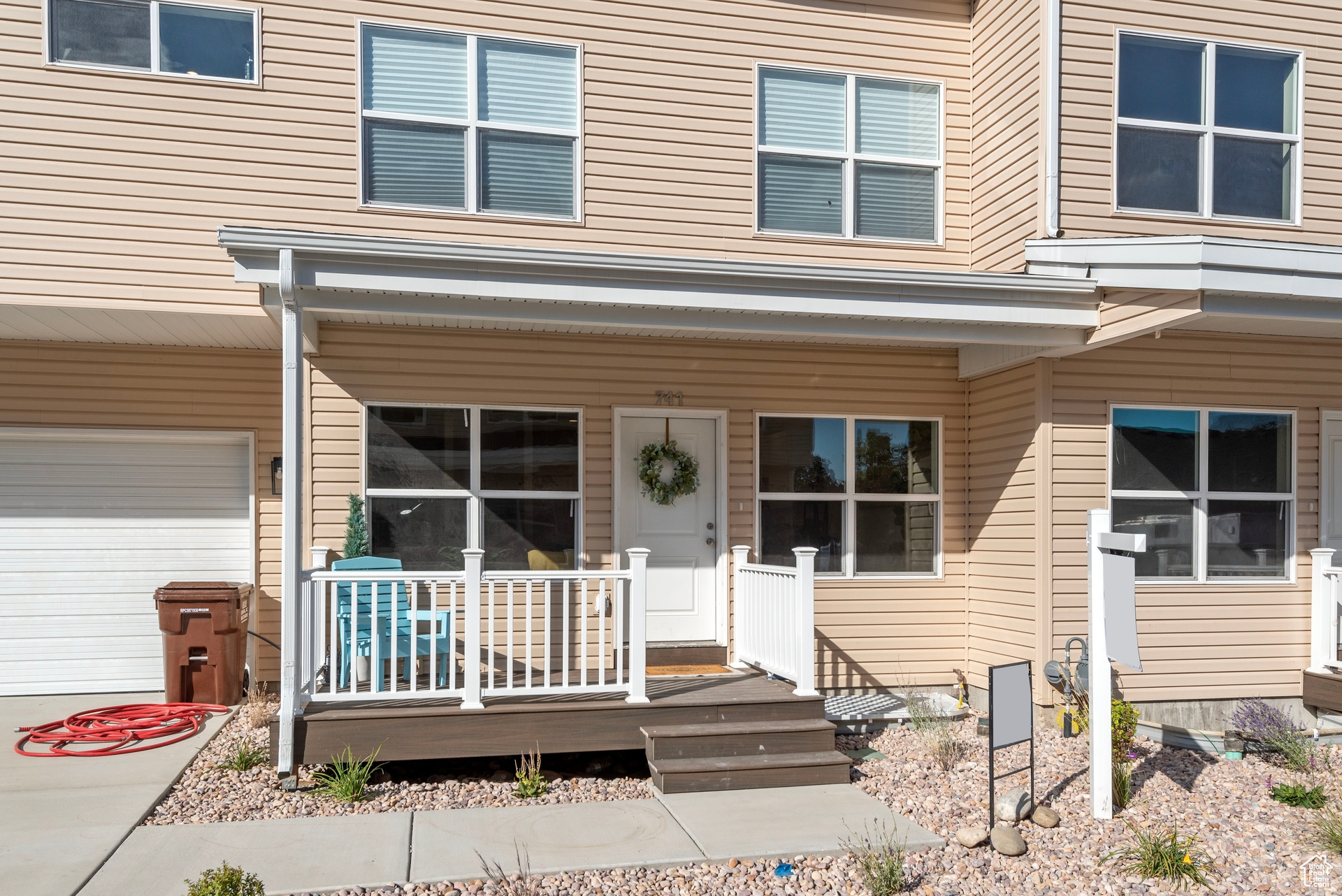 View of exterior entry with a garage and covered porch