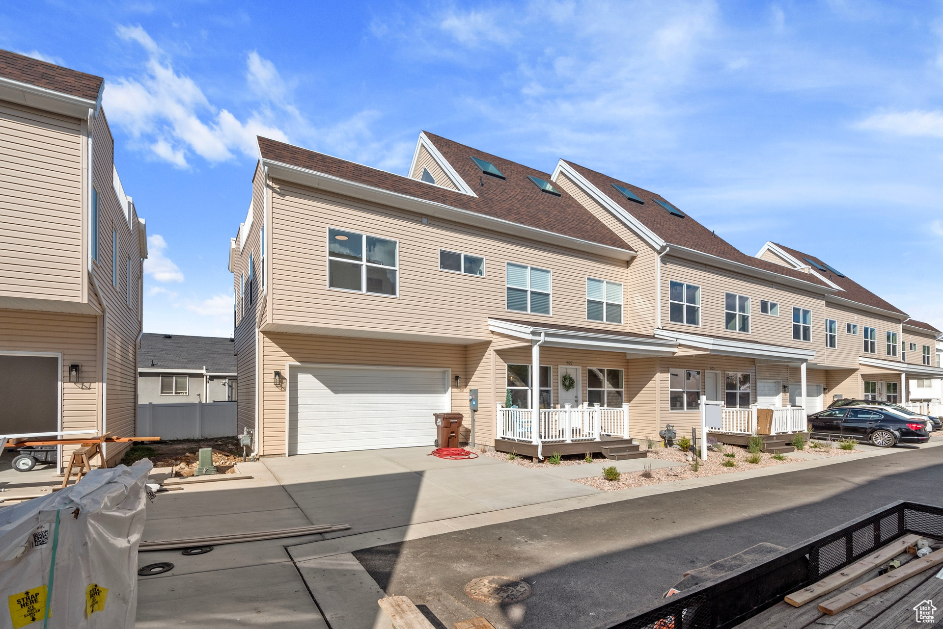 Townhome / multi-family property with a porch and a garage