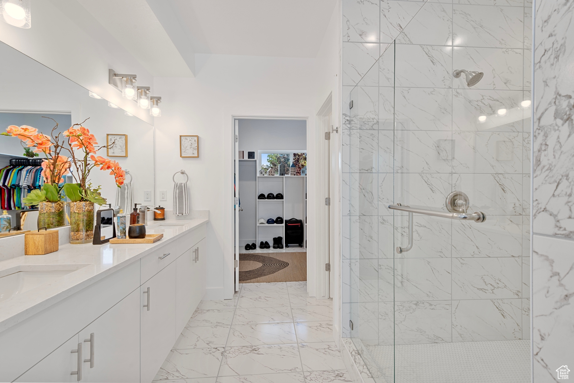 Bathroom with vanity and a shower with door