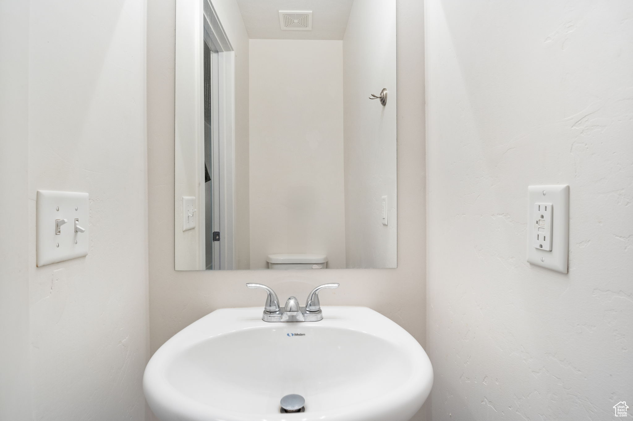 Bathroom featuring toilet and sink