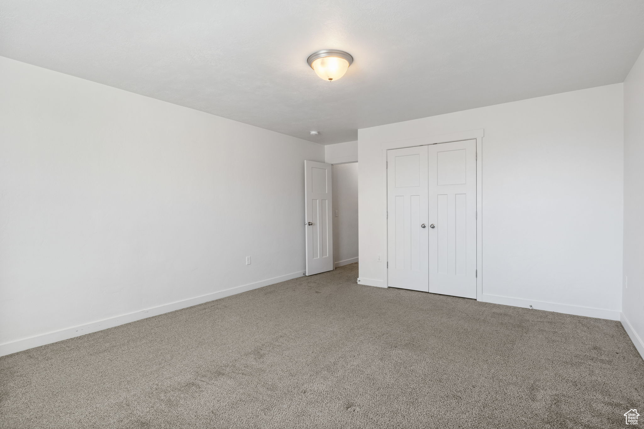 Unfurnished bedroom featuring a closet and carpet floors