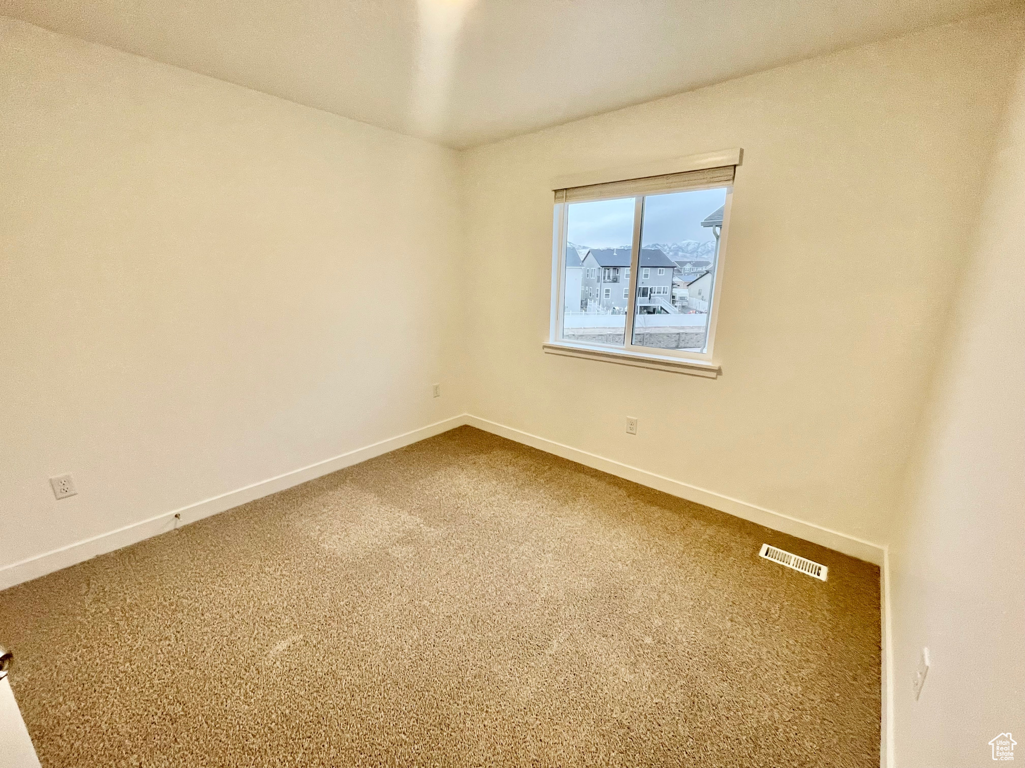 Empty room featuring carpet