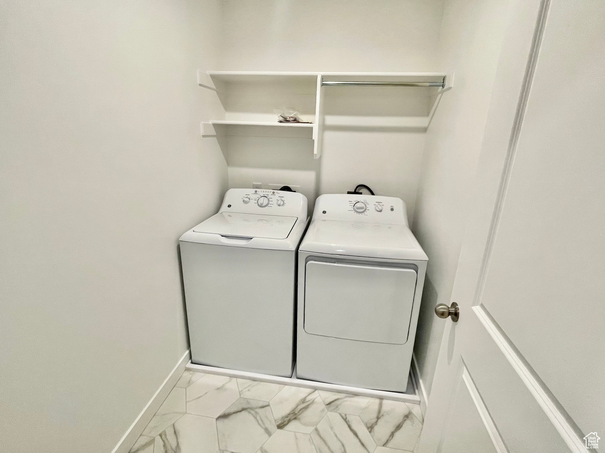 Clothes washing area featuring washer and clothes dryer