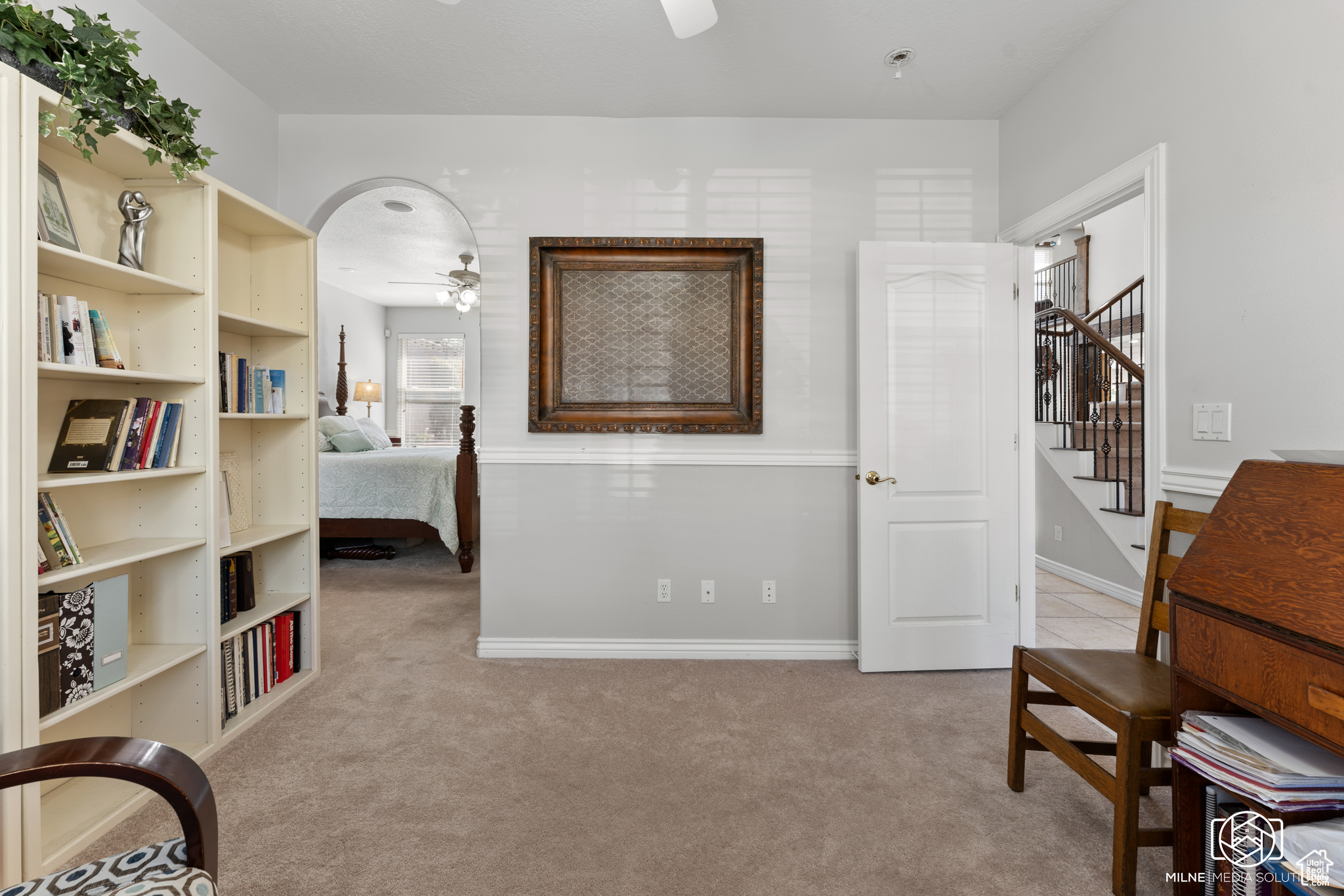 Bedroom featuring light carpet