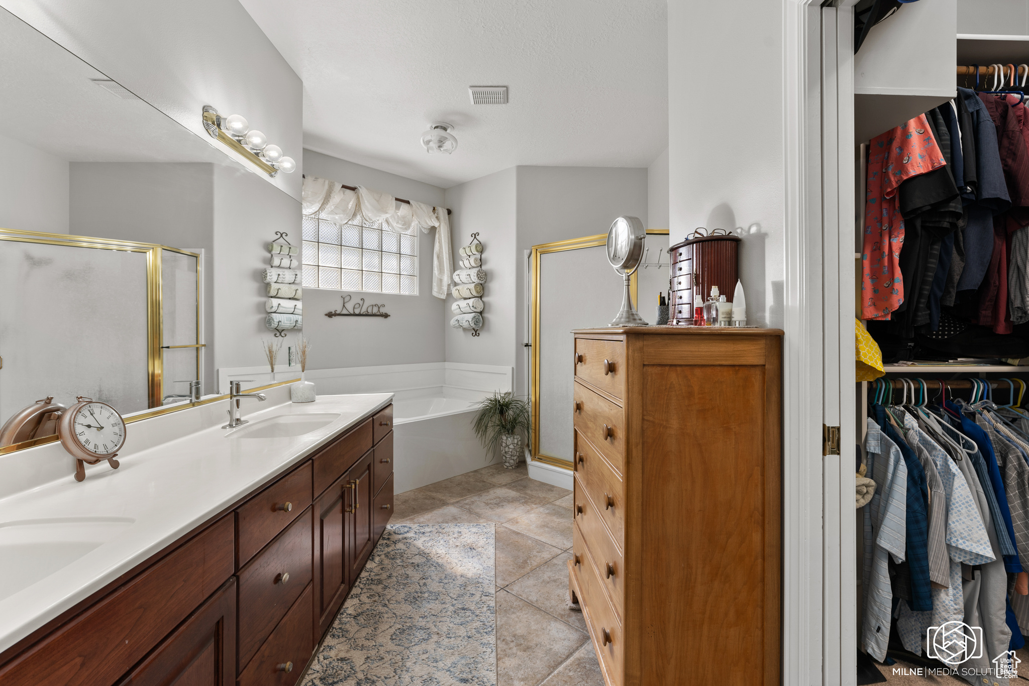 Bathroom with vanity, separate shower and tub, and tile patterned floors